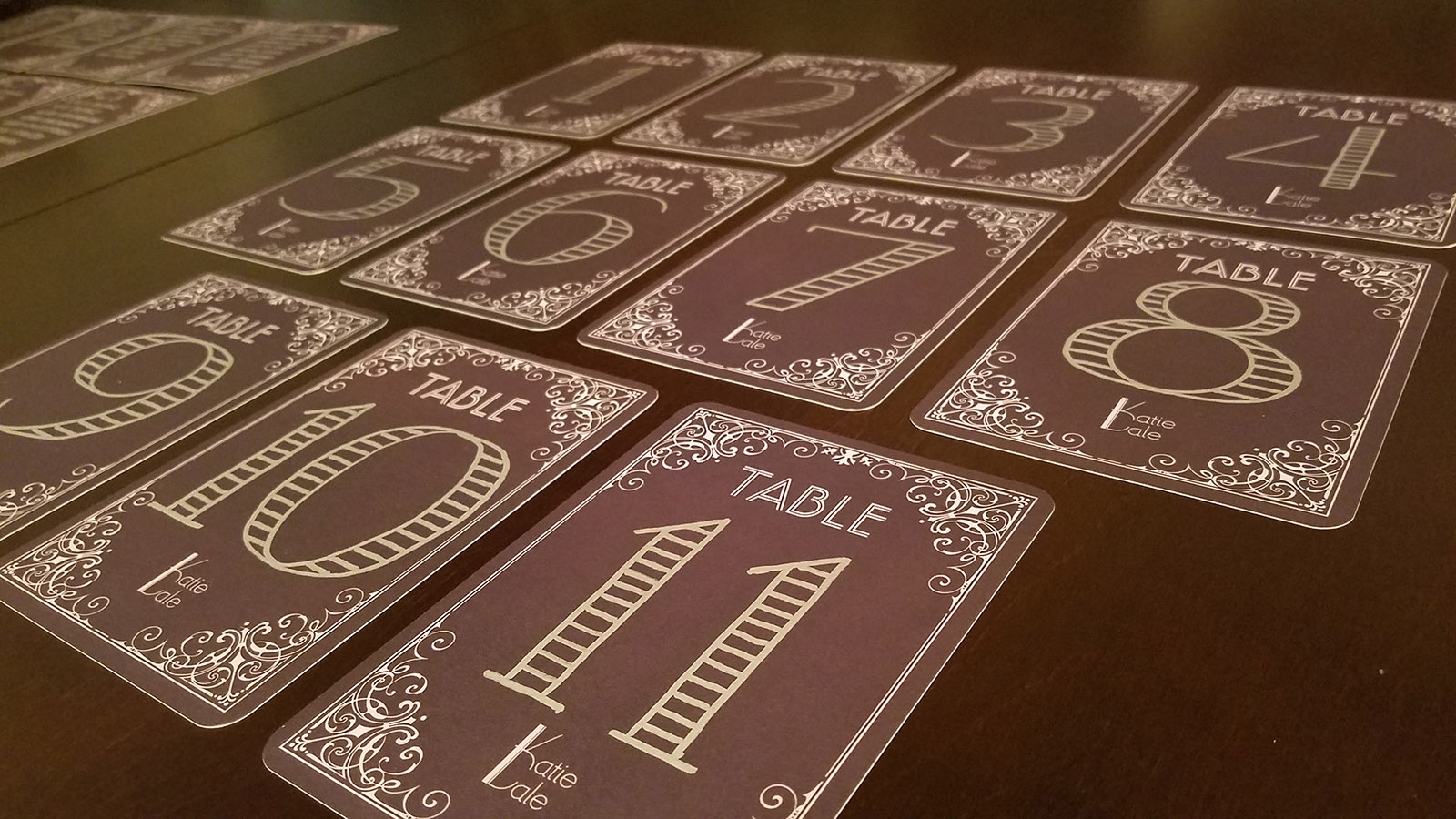 Hand-numbered table cards with logo