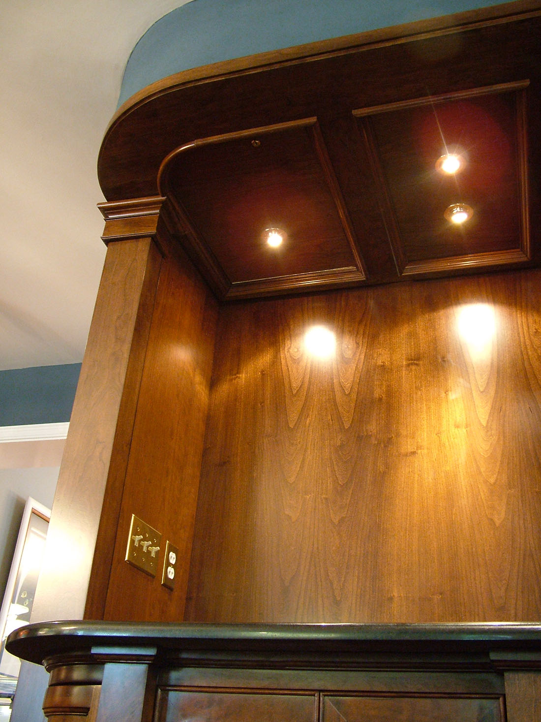 Ceiling panel of cabinetry with lighting and attic access panel